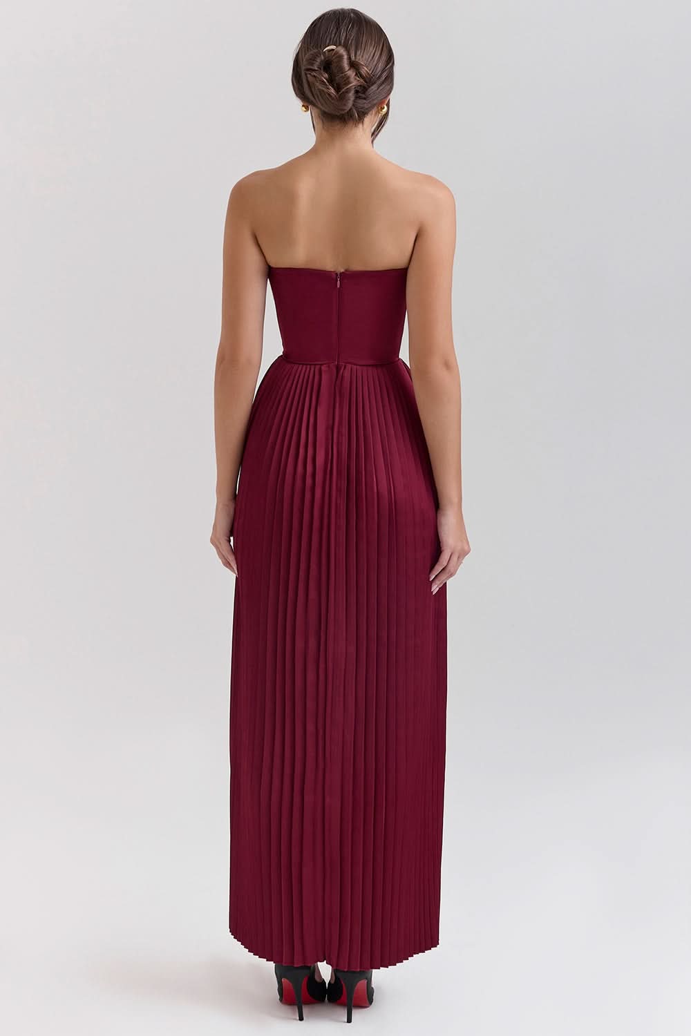 Rear view of burgundy maxi dress showing zip closure and pleated skirt
