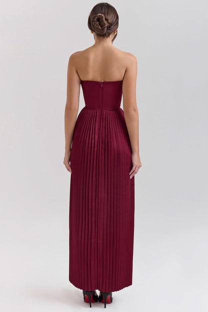 Rear view of burgundy maxi dress showing zip closure and pleated skirt