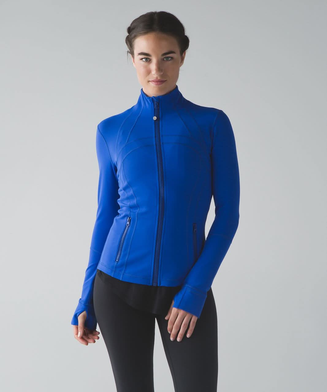 Bright blue define jacket with navy zip and curved seaming