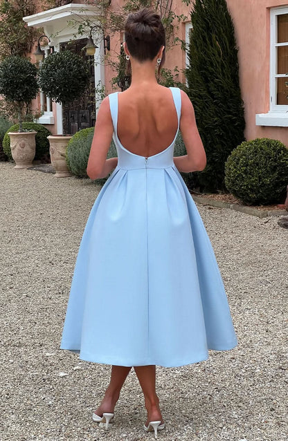 Back view of light blue midi dress showing open back design and zip closure