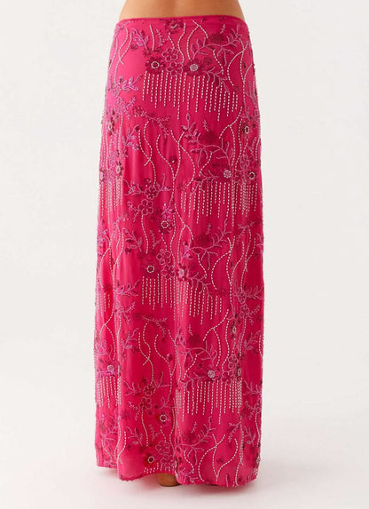 pink maxi skirt detail showing ornate beaded flowers and dangling bead accents