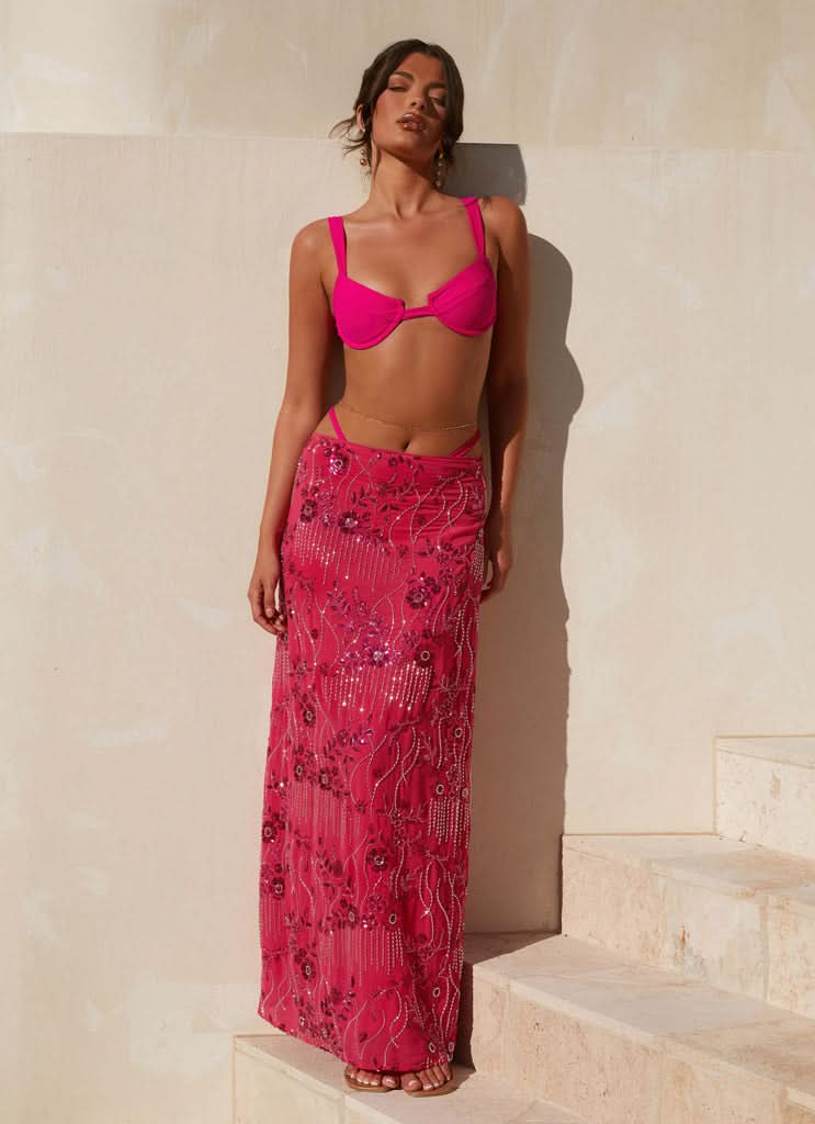 Full-length pink sequined maxi skirt styled with matching bikini top