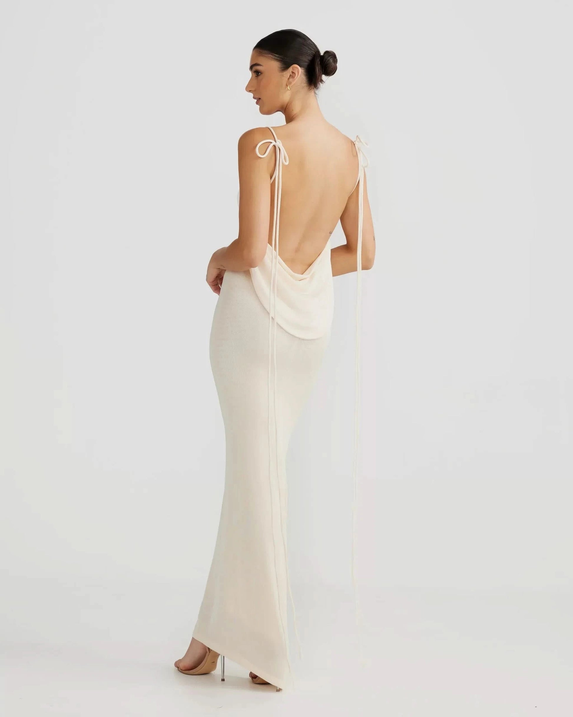 Cream tie-strap backless maxi dress with cowl back draping, full-length side view for women
