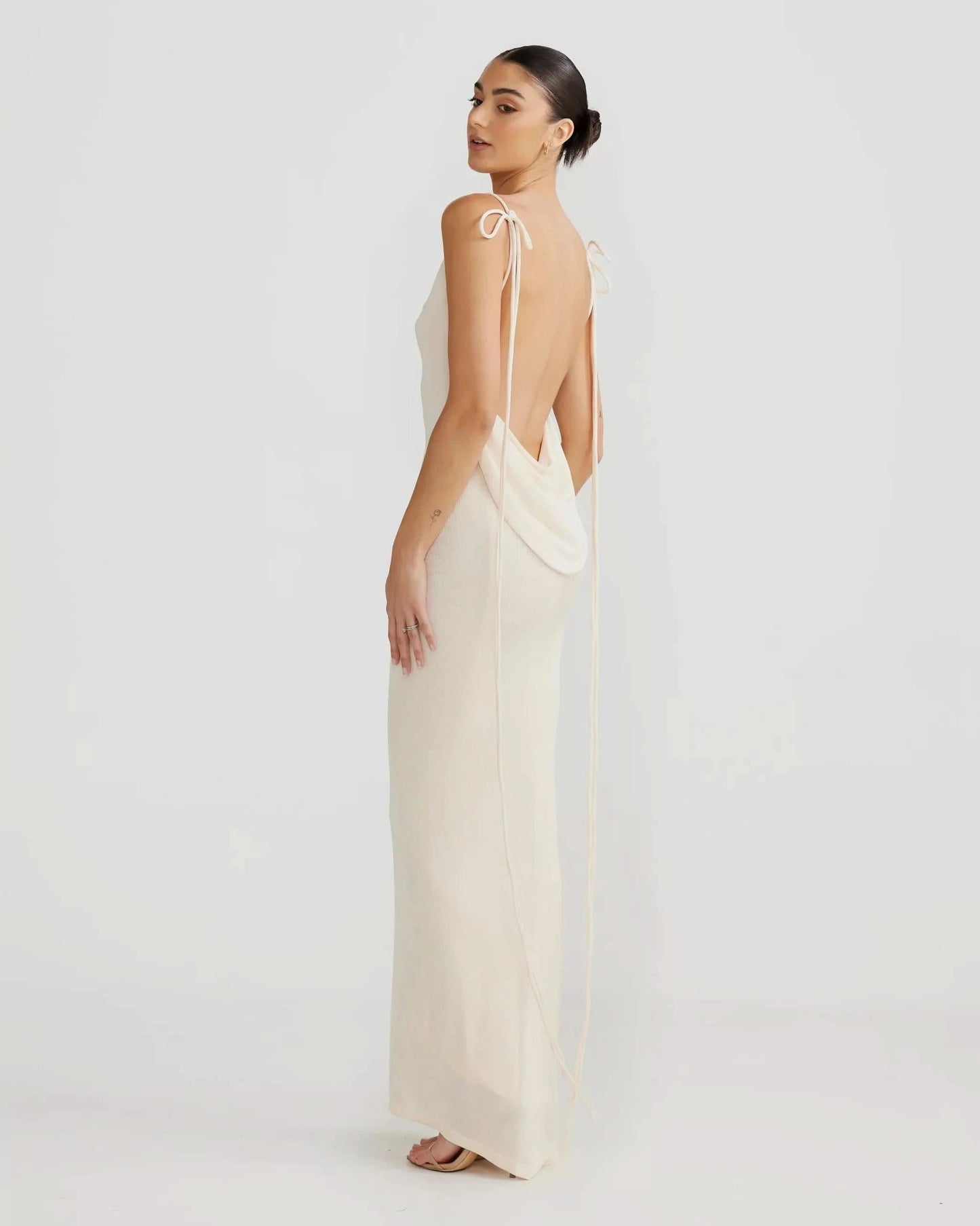 Cream knit backless maxi dress with open back design, side profile view for women