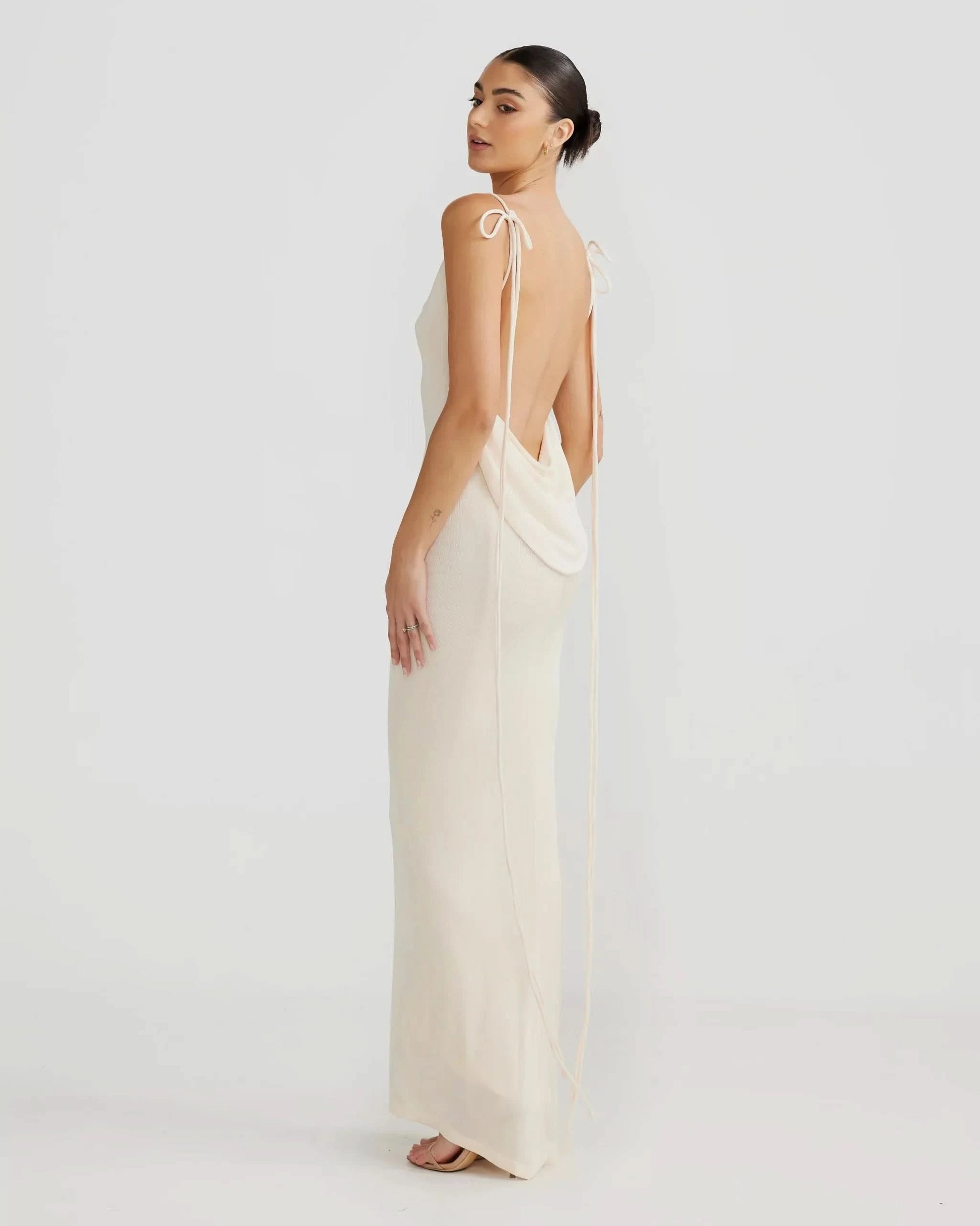 Cream knit backless maxi dress with open back design, side profile view for women