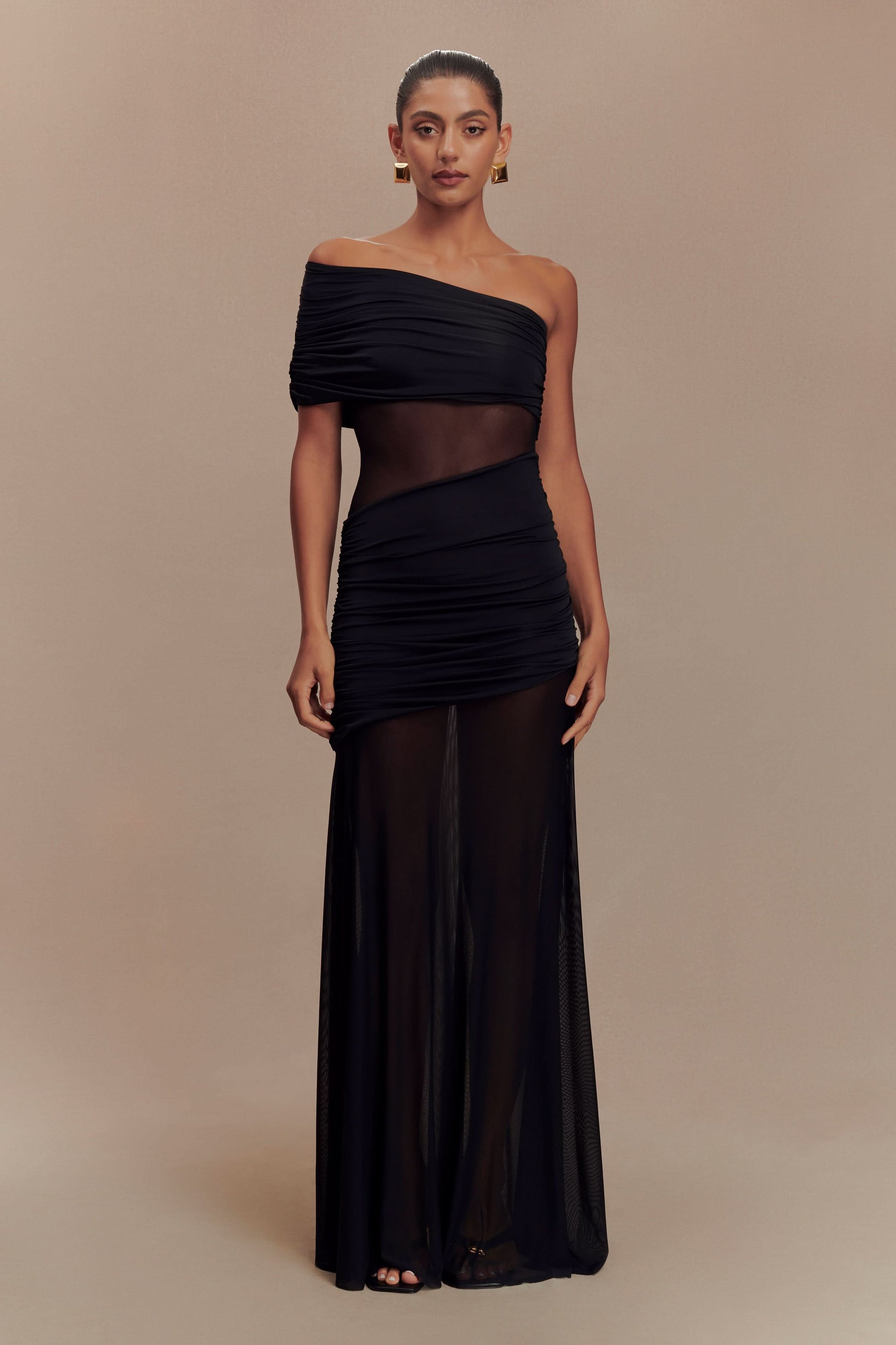 Black off-shoulder evening gown with ruched fabric and flowing maxi skirt