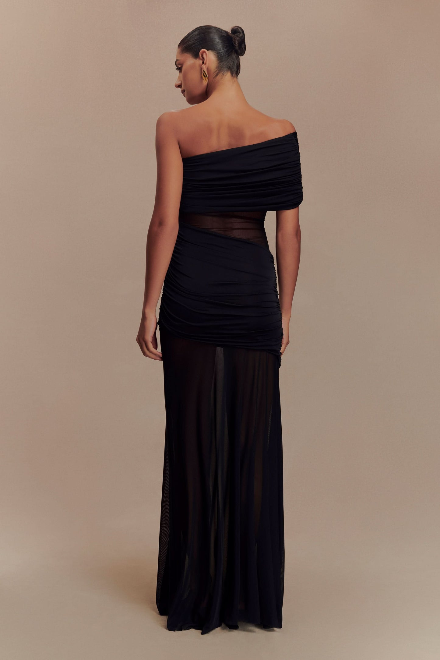 Back view of black off-shoulder maxi dress showing ruched details