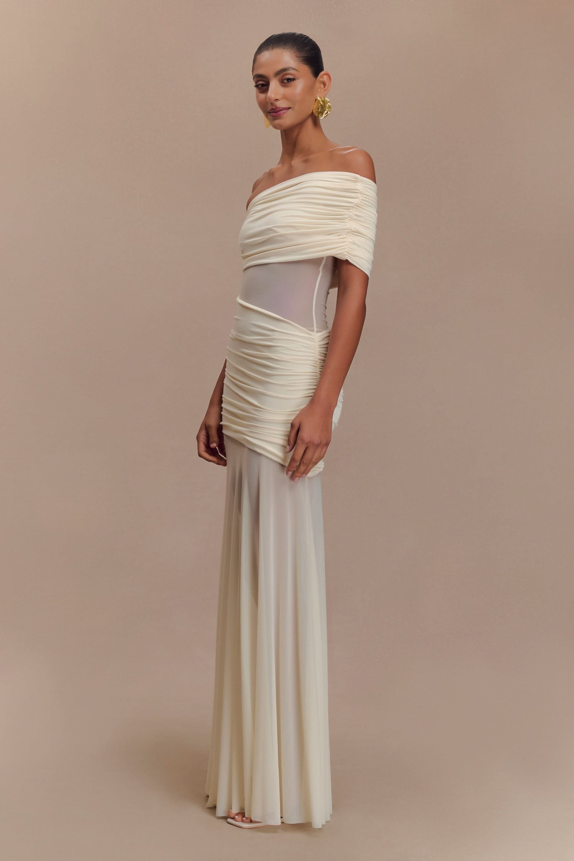 Cream off-shoulder maxi dress with ruched bodice and sheer waist insert
