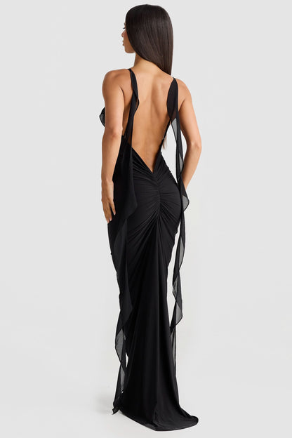 Black maxi dress back view with open back, ruched center detail, and sheer trailing panels