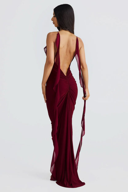 Burgundy maxi dress back view showing deep open back with ruched detail and flowing train