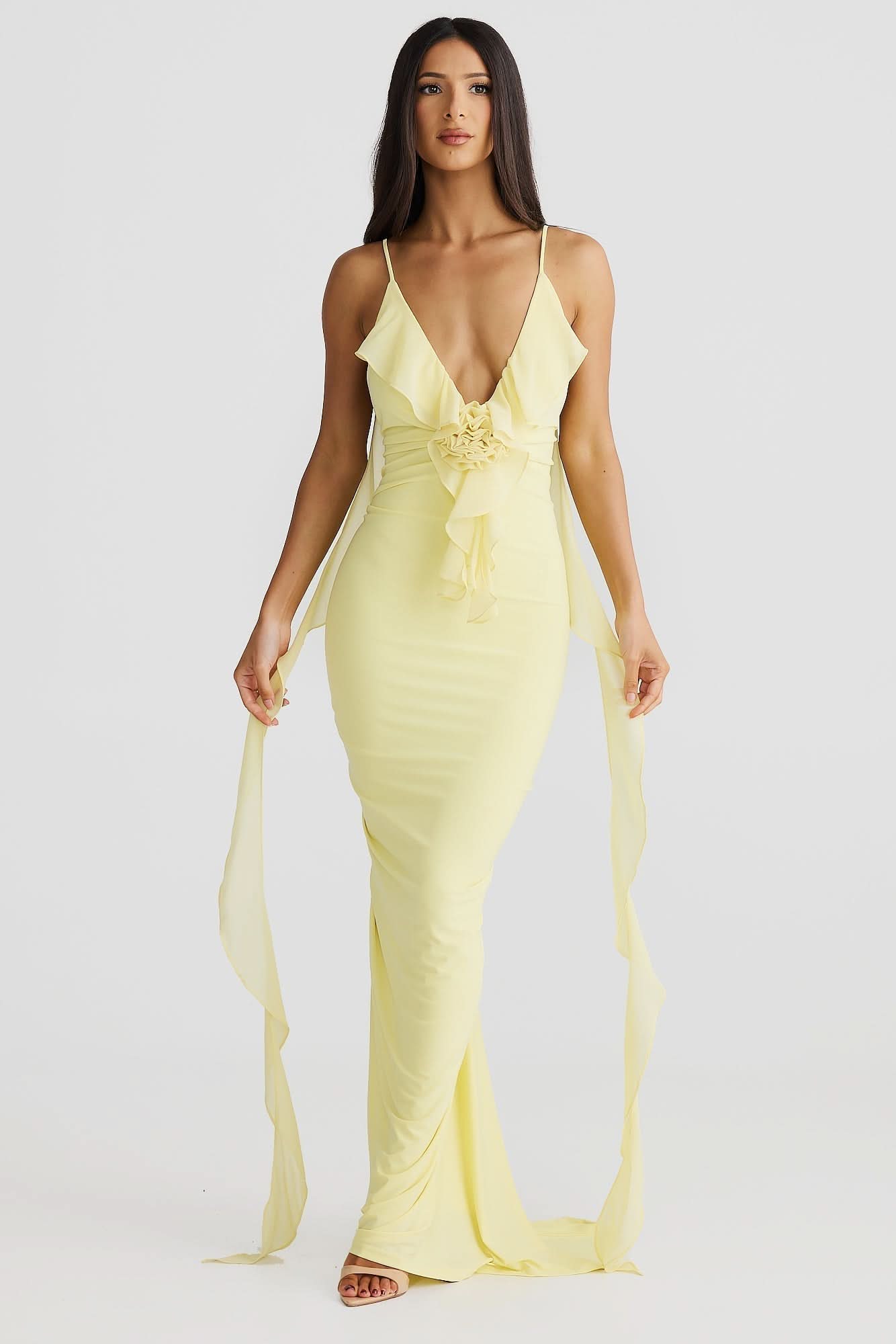 Yellow wrap maxi dress with deep V-neckline, ruched waist detail, and flowing chiffon train