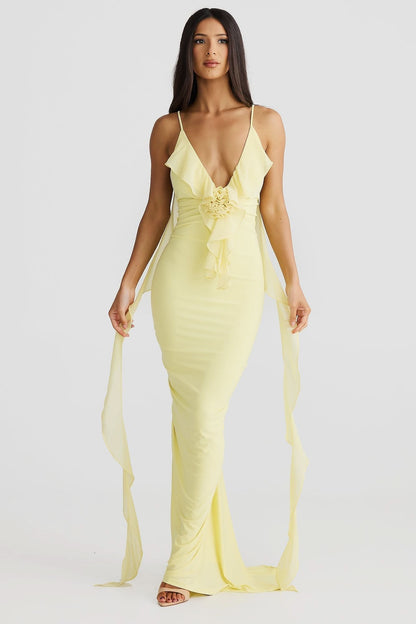 Yellow wrap maxi dress with deep V-neckline, ruched waist detail, and flowing chiffon train