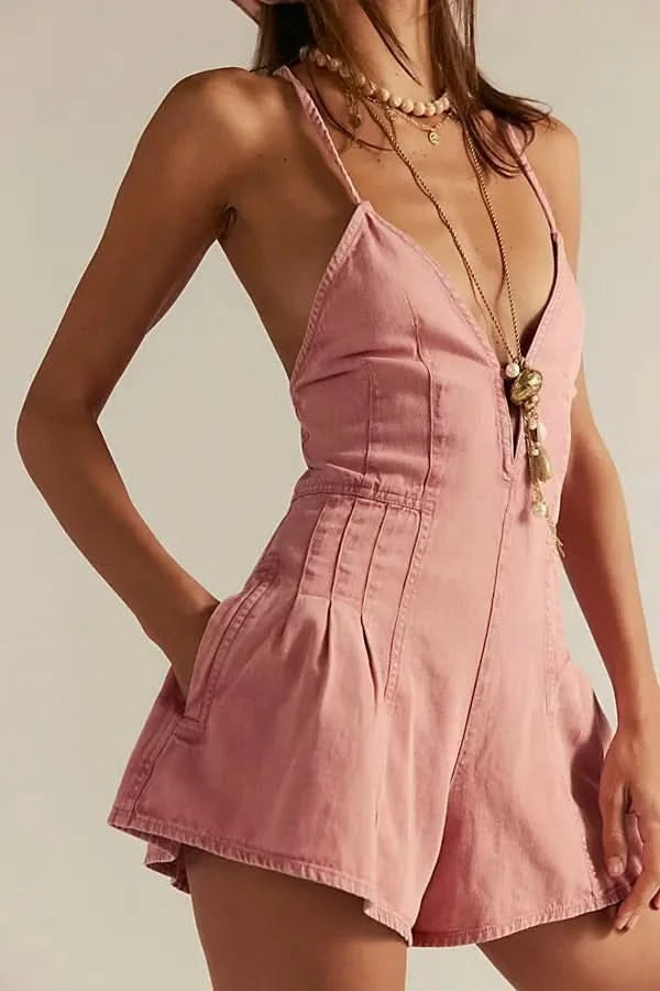 Mauve denim romper with V-neckline and pleated shorts, side view