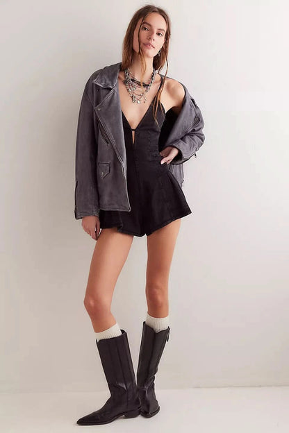 Black denim romper with V-neckline styled with oversized denim jacket