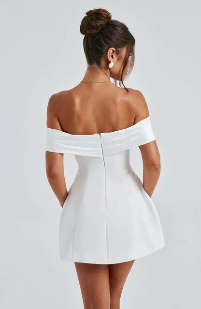 Back view of white off-shoulder mini dress with draped bow detail
