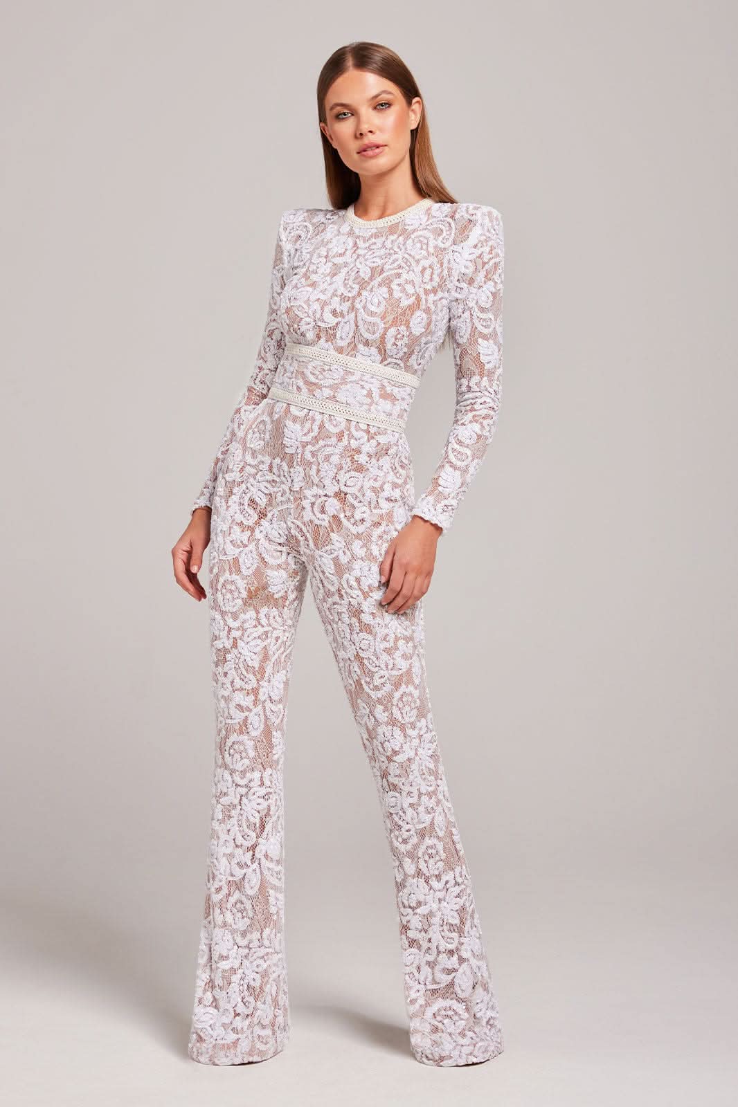 White lace jumpsuit with long sleeves and cream waist belt