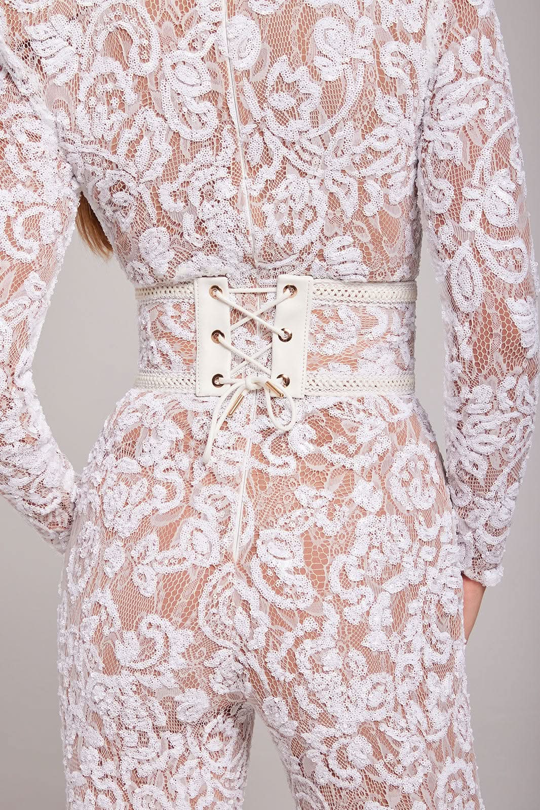 Full-length white lace jumpsuit with flared legs and waist belt