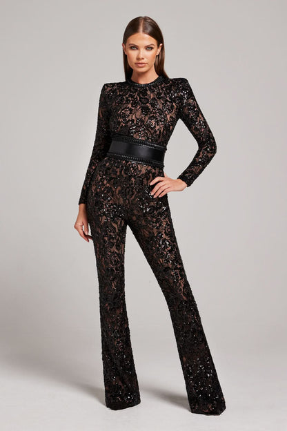 Black lace jumpsuit with long sleeves and studded waist belt