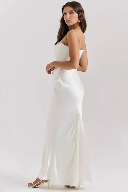 Back view of cream corset maxi dress showing open back and fitted silhouette