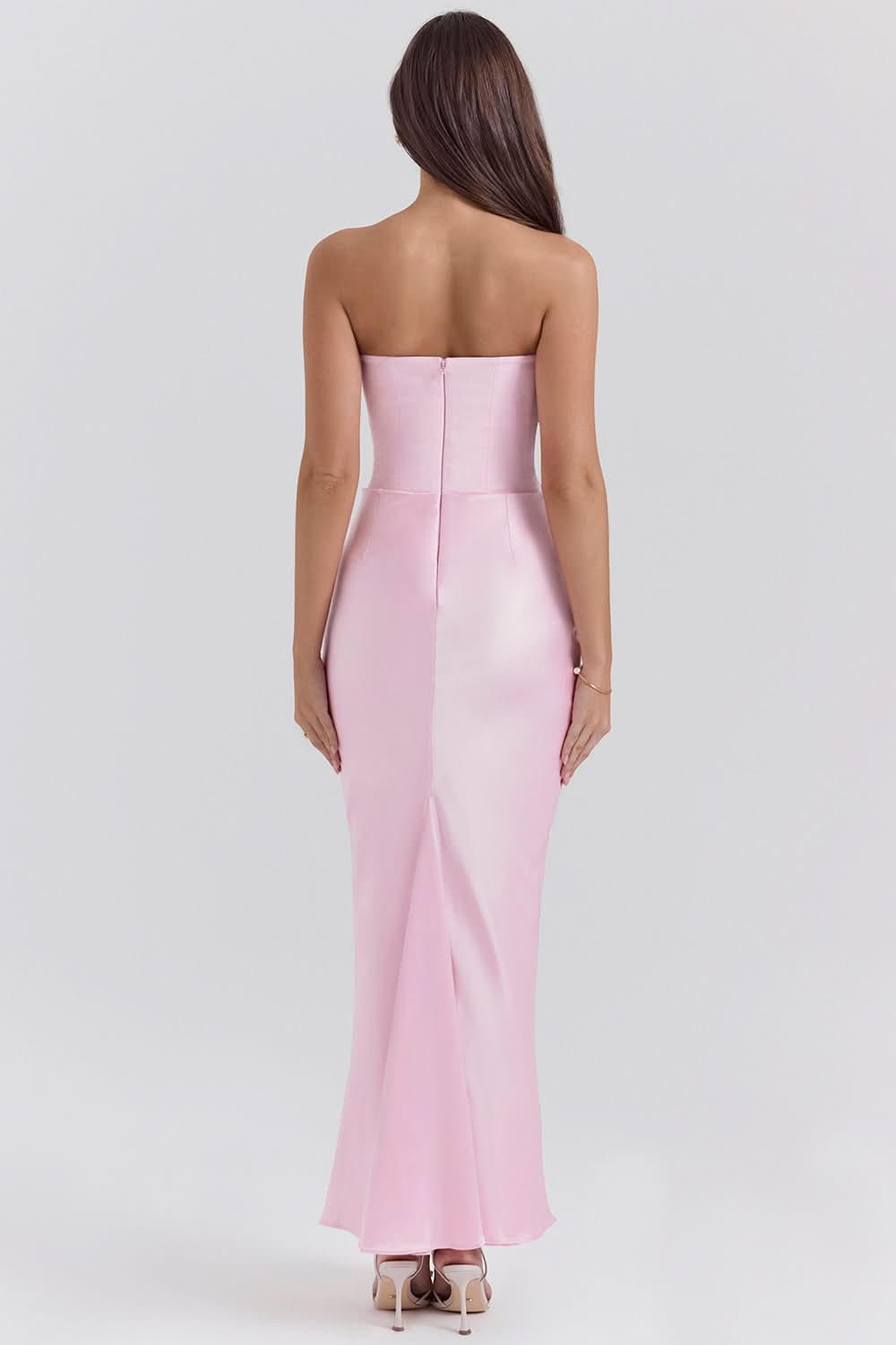 Pink strapless corset maxi dress with fitted bodice and slit skirt, back view