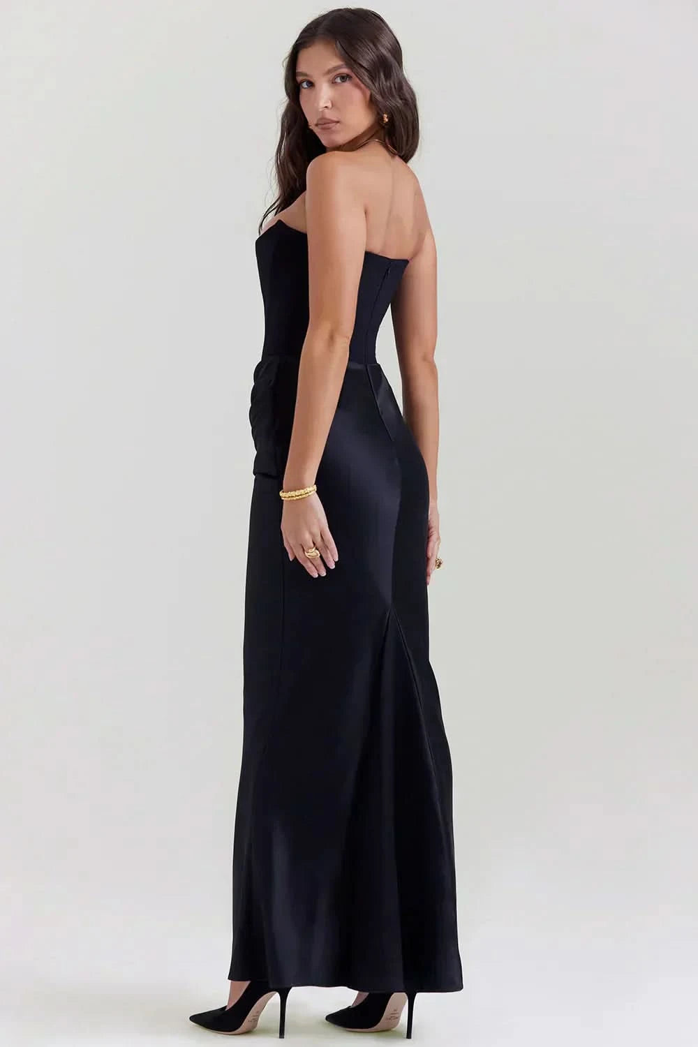 Back view of black corset maxi dress showing open back design