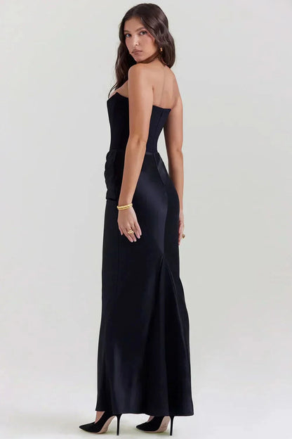 Back view of black corset maxi dress showing open back design
