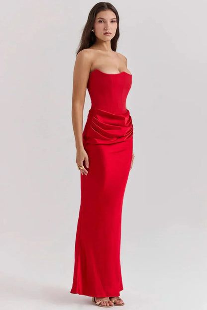 Side view of red corset maxi dress with draped hip ruching detail