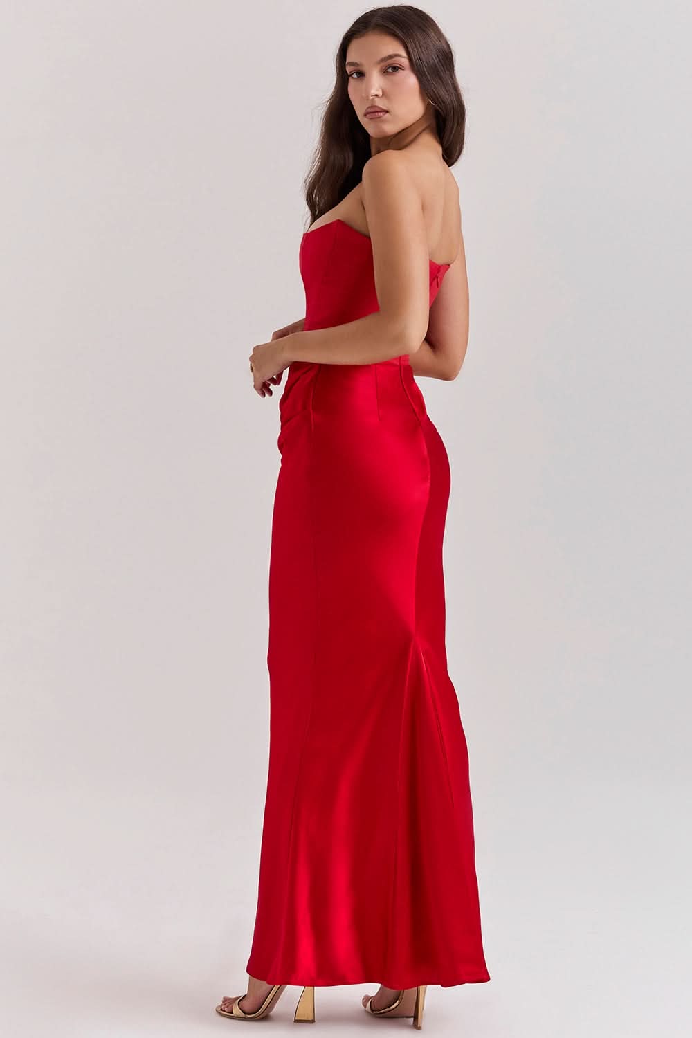 Back view of red strapless corset maxi dress with fitted silhouette