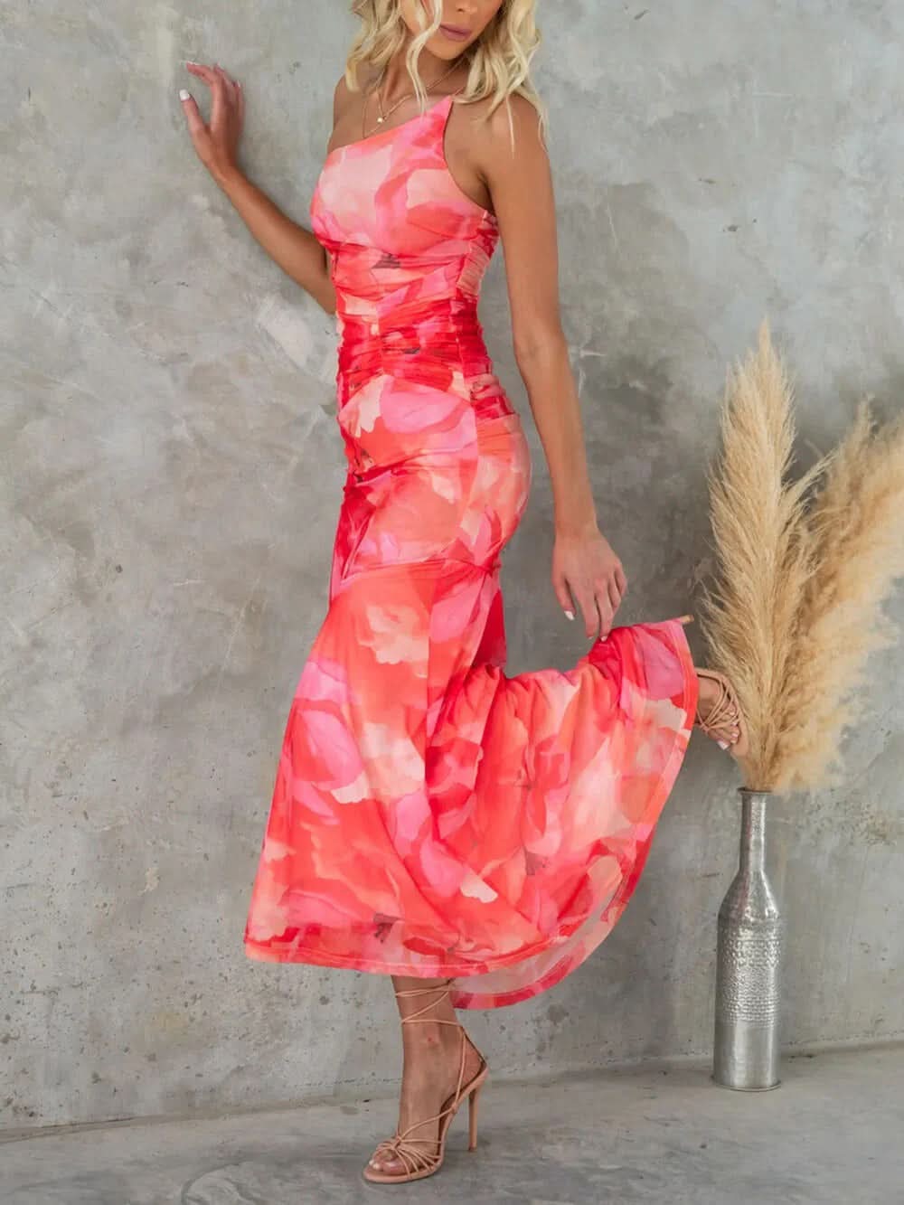Side view of coral pink floral maxi dress with flowing skirt