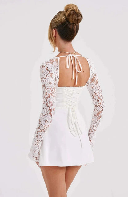 White lace mini dress back view with open tie-back detail and long sleeves