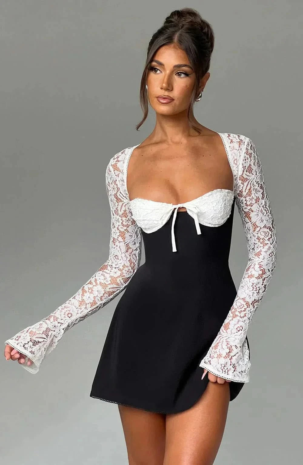 Black and white lace mini dress with contrast lace sleeves and bow detail