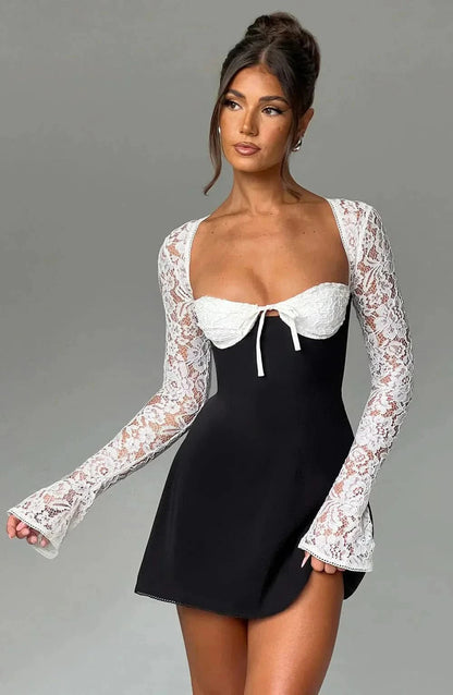 Black and white lace mini dress with contrast lace sleeves and bow detail
