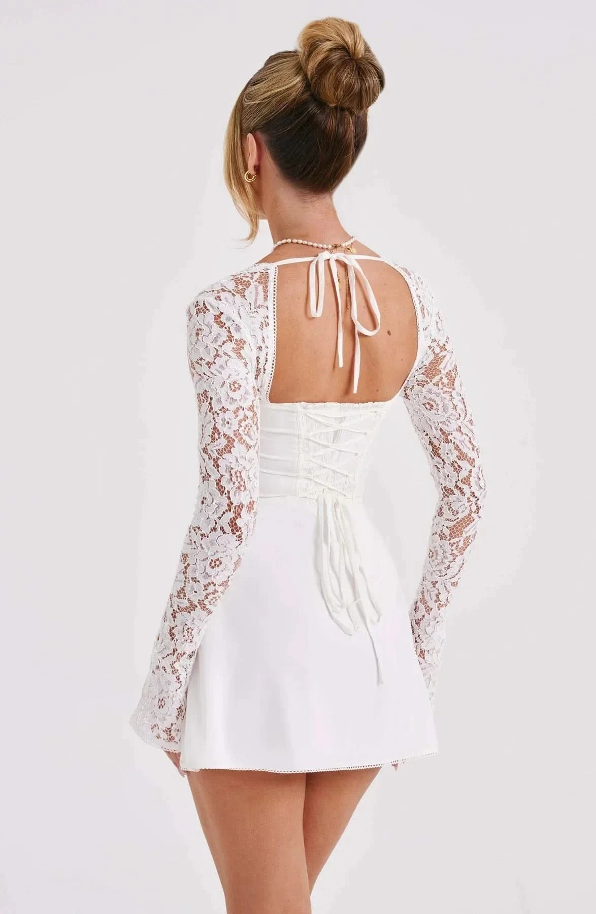 Black and white lace mini dress with contrast lace sleeves and bow detail