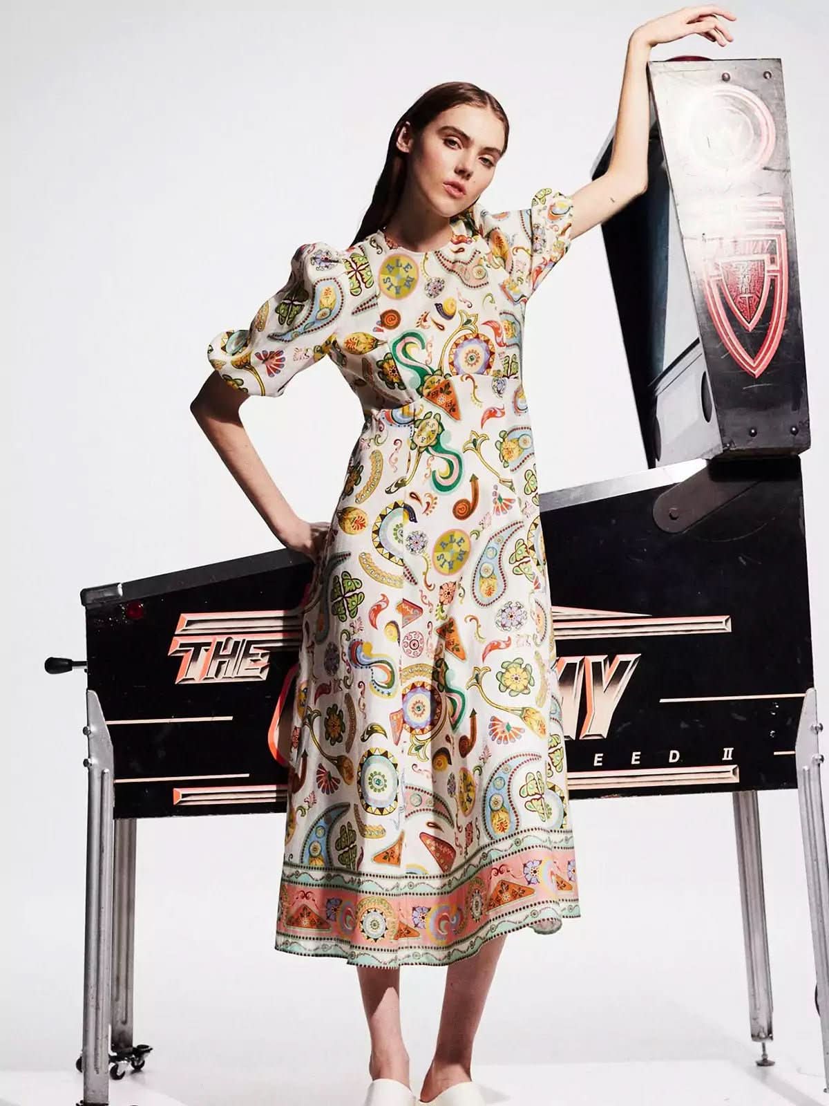 Front view of cream midi dress with colorful print, three-quarter sleeves and flared skirt