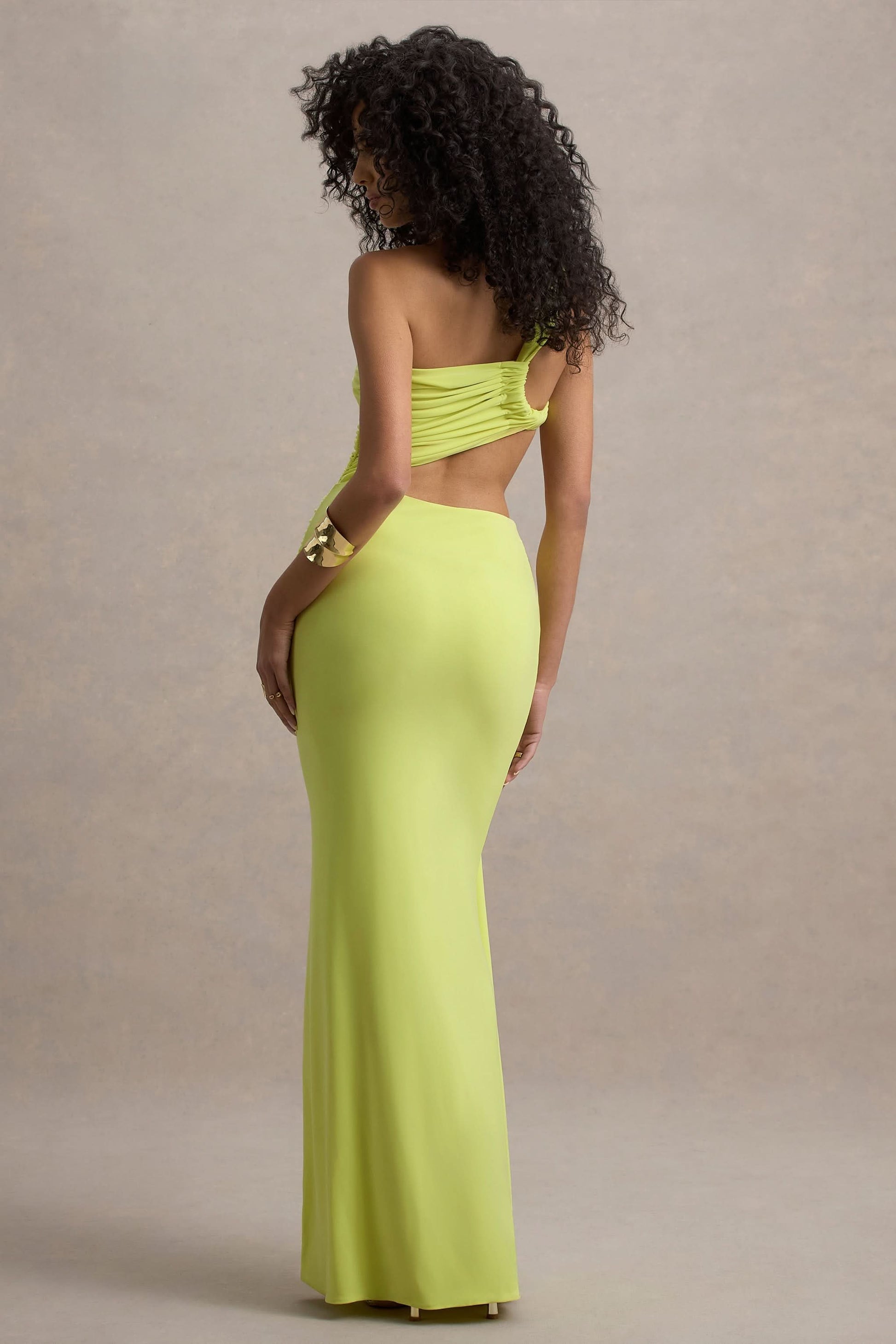 Back view of lime asymmetric maxi dress showing open back cutout design