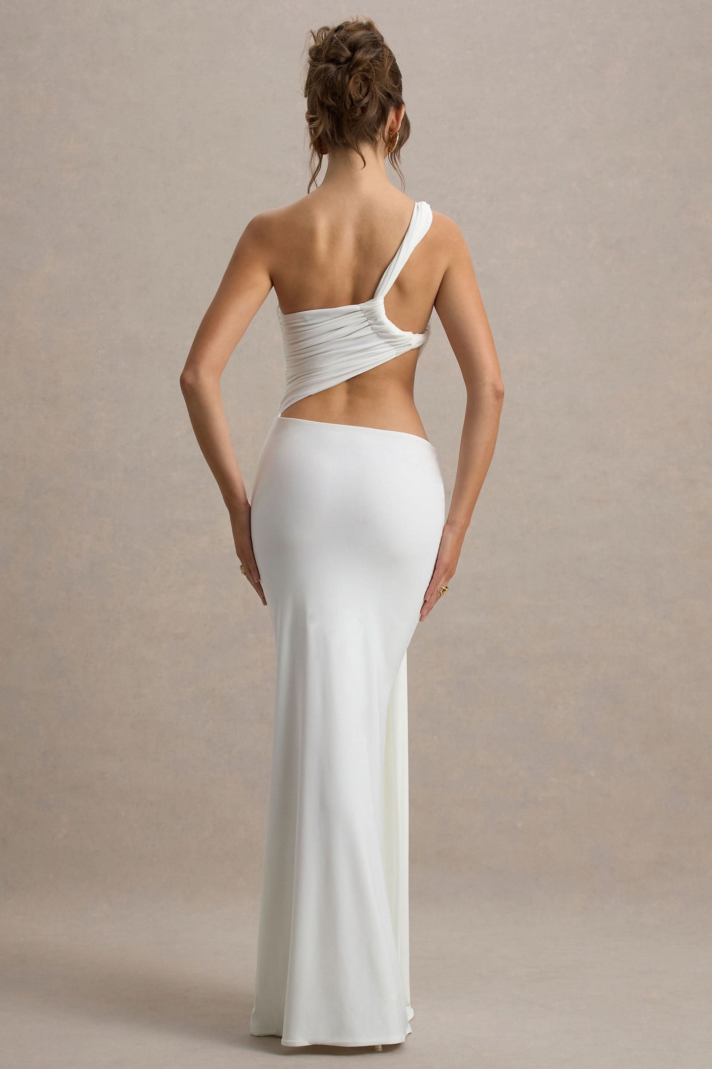 Back view of white asymmetric maxi dress with open back cutout detail