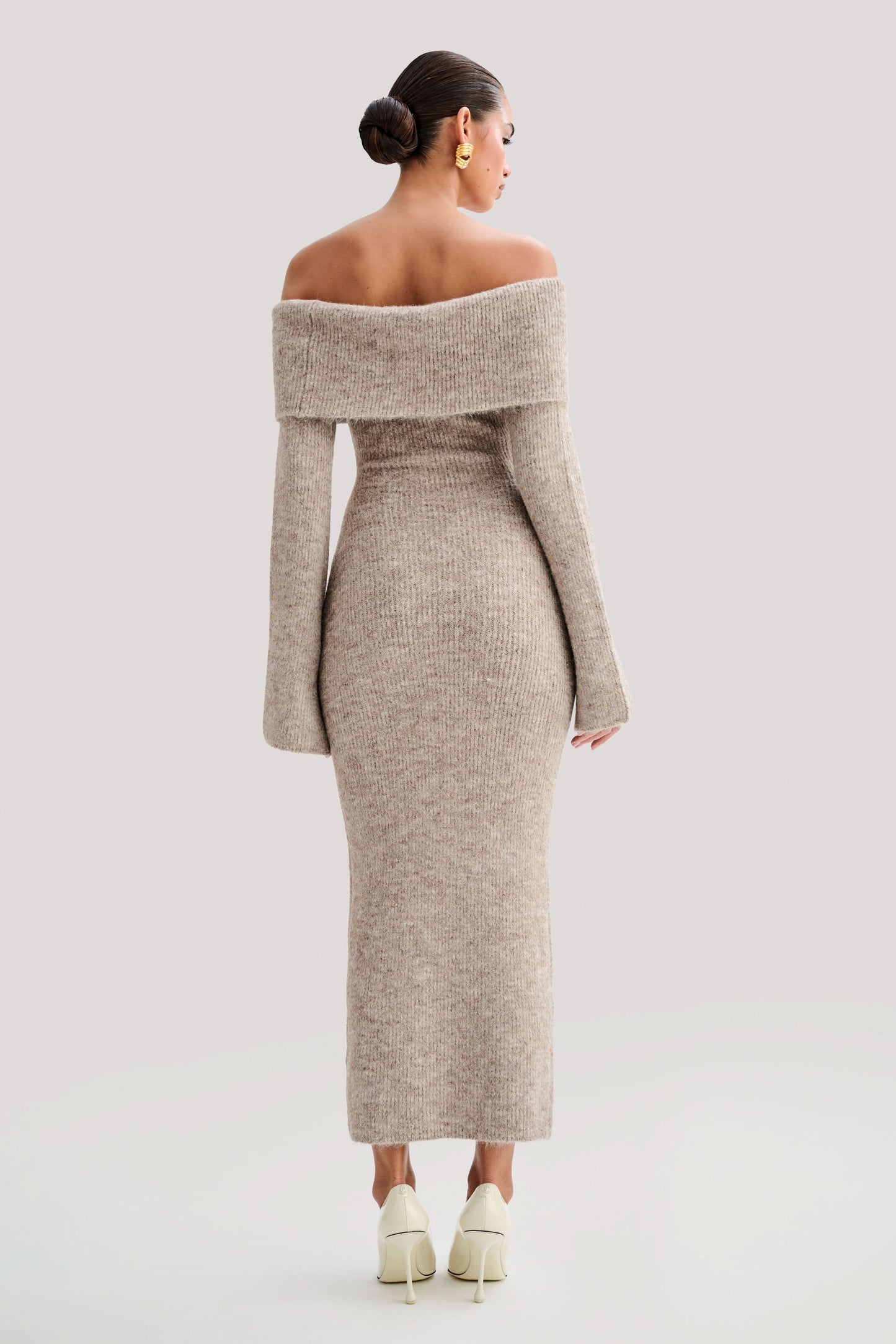 Back view of beige off-shoulder knit midi dress with folded collar detail