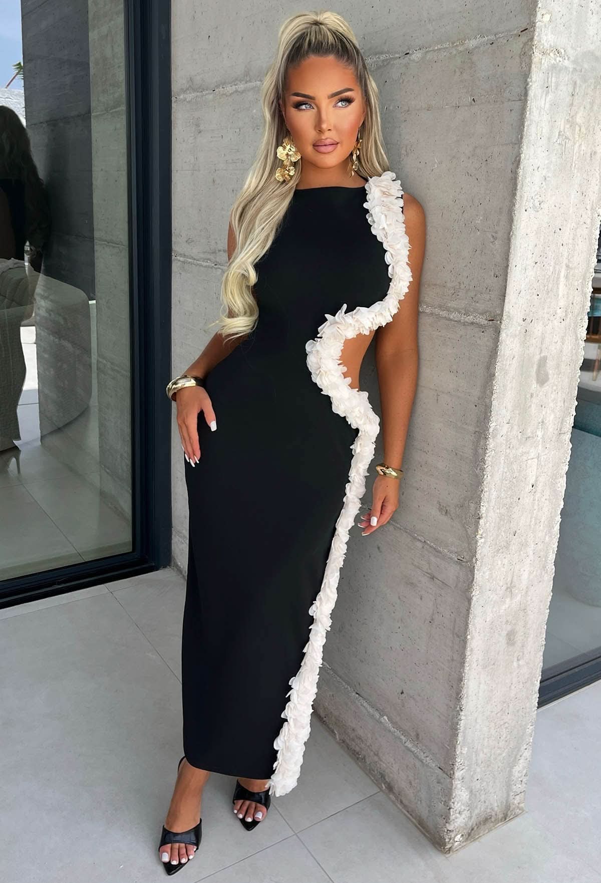 Black maxi dress with white ruffle cutout details front view