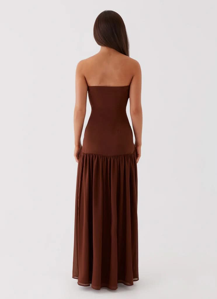 Black strapless maxi dress with high thigh slit and pleated hem detail, front view