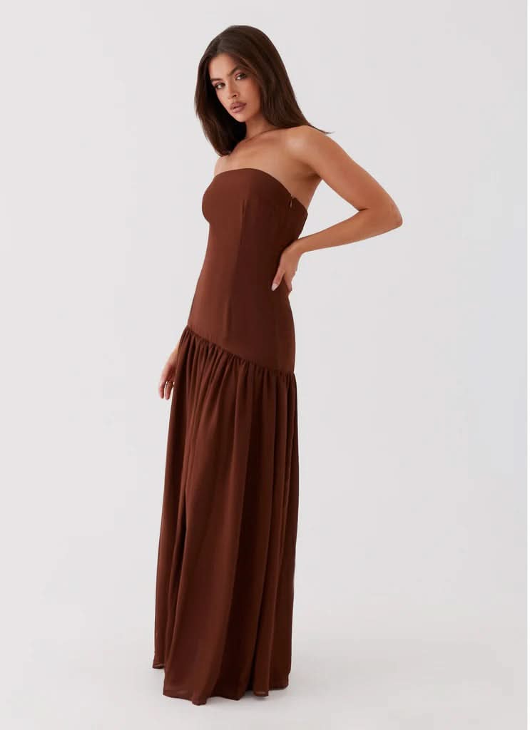 Chocolate brown strapless maxi dress with gathered hem, side angle view