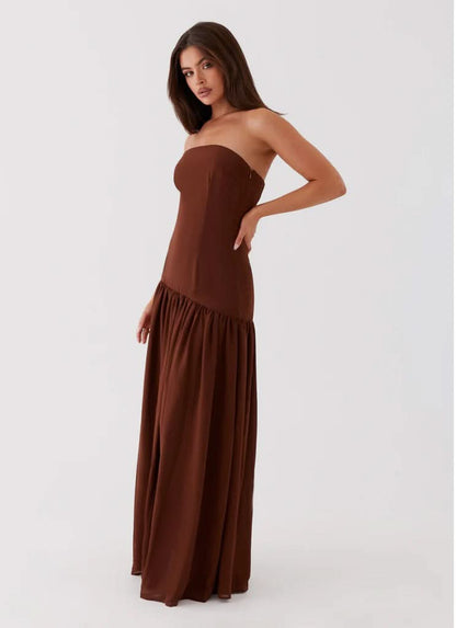 Chocolate brown strapless maxi dress with gathered hem, side angle view