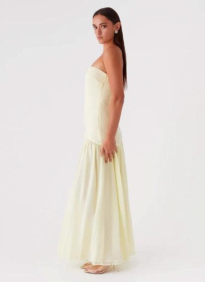 Pale yellow strapless maxi dress with high leg slit and gathered skirt, full length