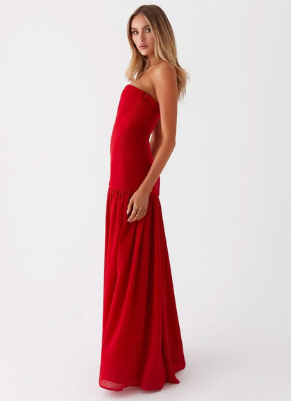 Red strapless maxi dress at beach showing side slit and draped skirt