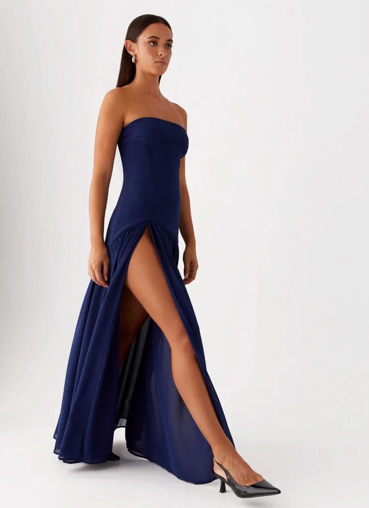 Navy strapless maxi dress with gathered waist and floor-length skirt, back view
