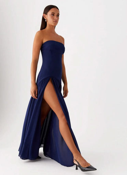 Navy strapless maxi dress with gathered waist and floor-length skirt, back view