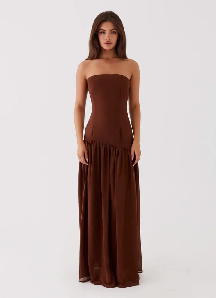 Navy strapless maxi dress with ruched waist and flowing skirt, full length