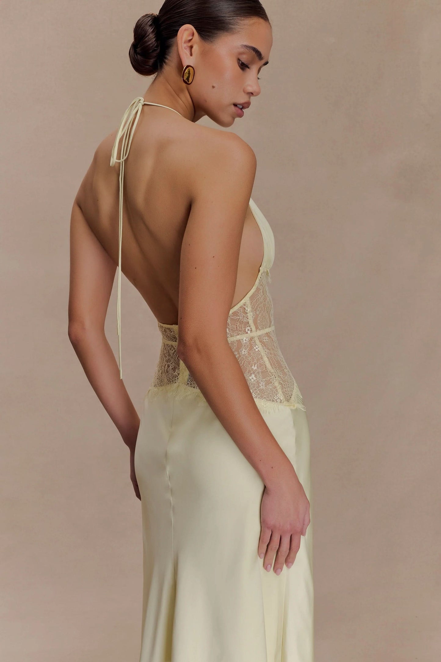 Back detail of cream maxi dress showing open back and lace trim