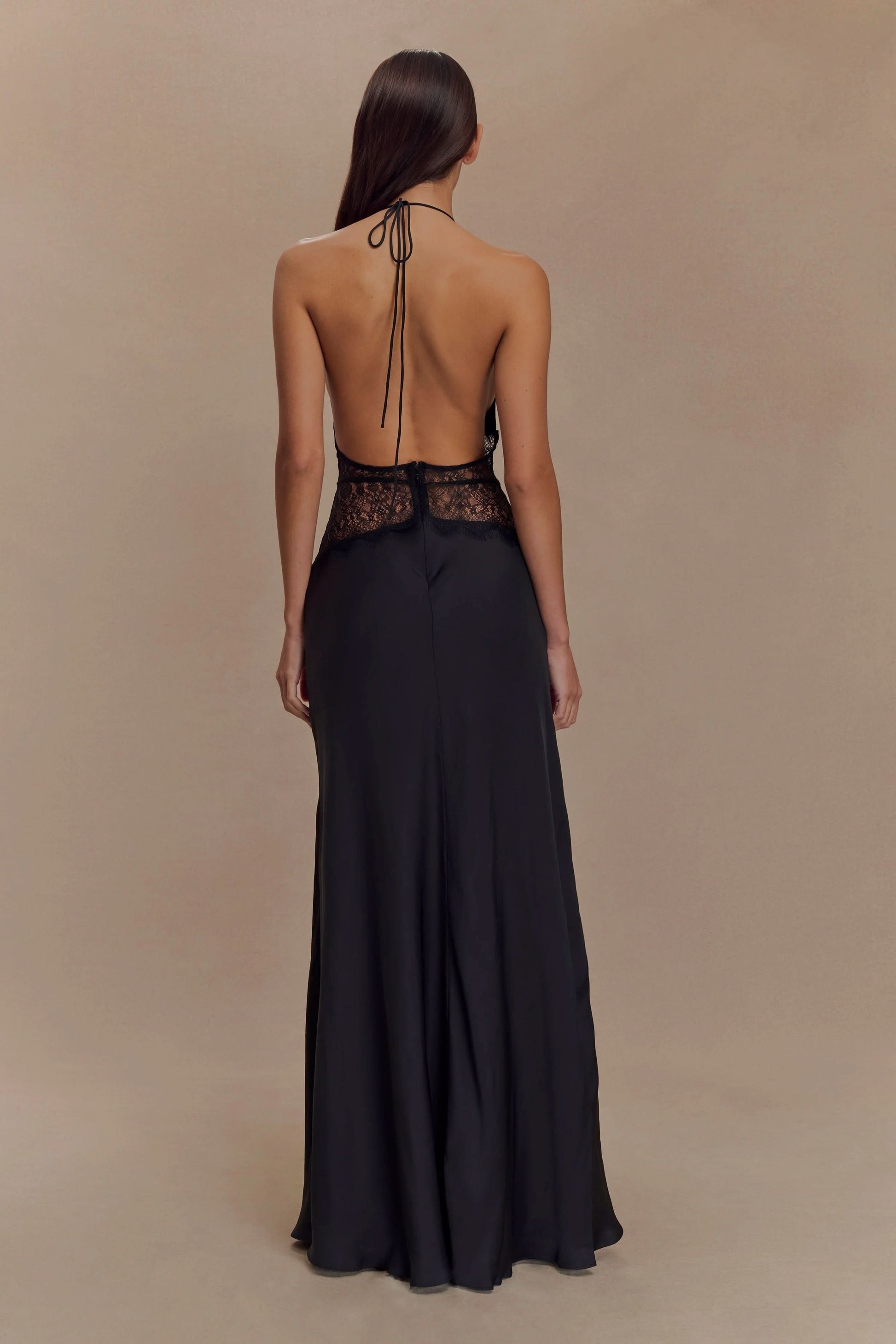 Back view of black maxi dress with halter tie and lace waistband