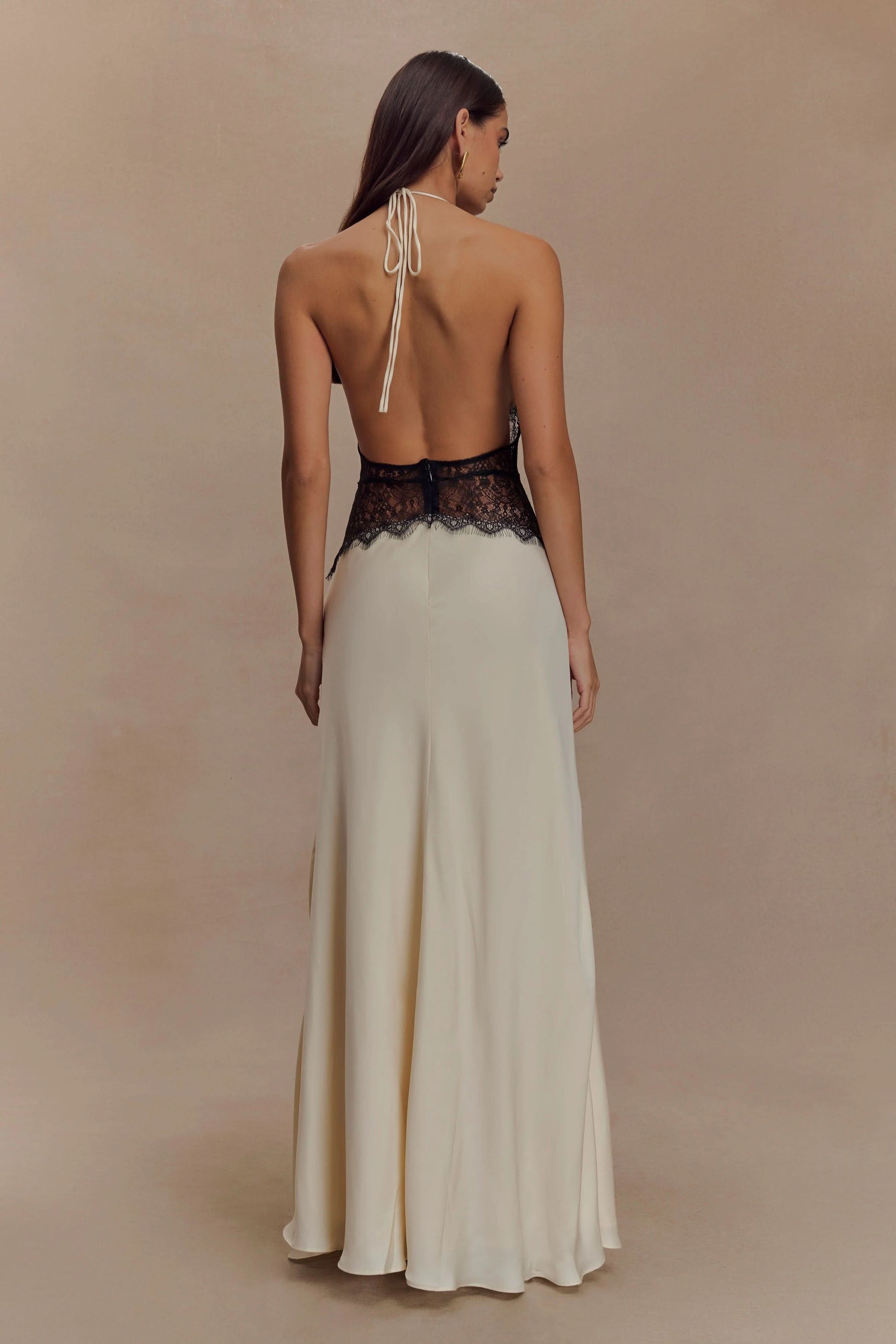 Back view of cream maxi dress with halter tie and lace detail
