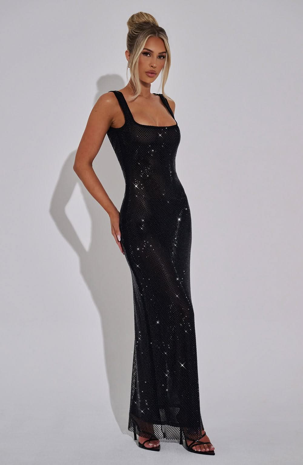 Black sequin maxi dress with square neckline and fitted silhouette